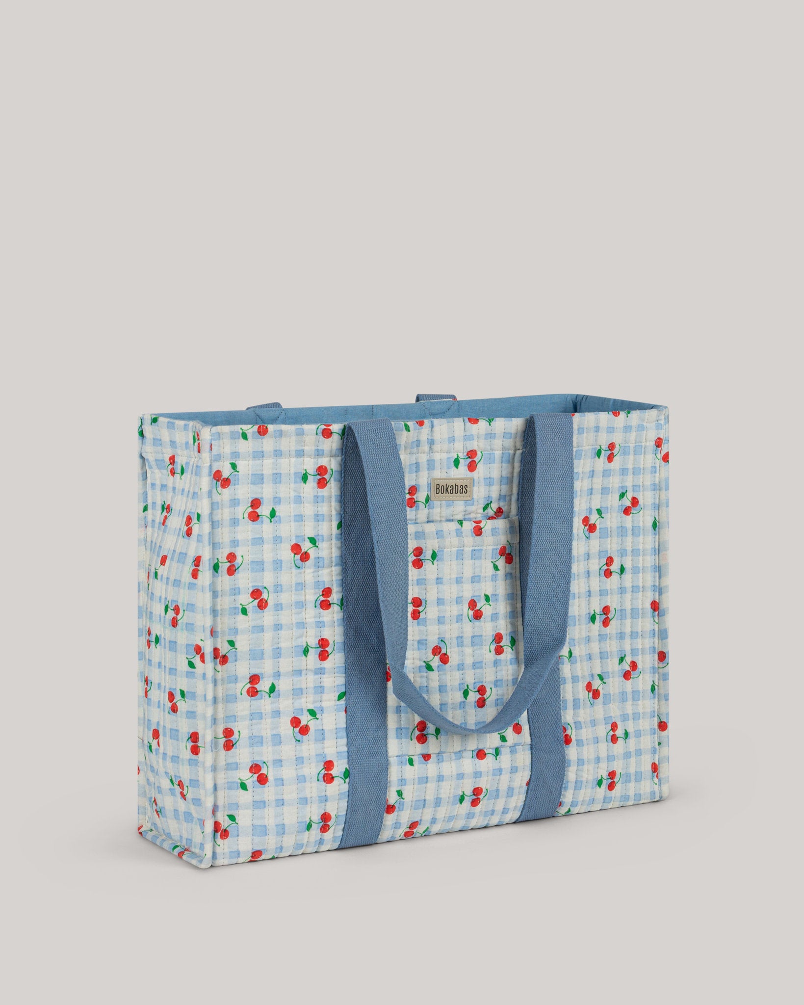 A bolsa tote em tecido acolchoado Cerise azul